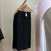 Load image into Gallery viewer, Black skirt with white stitching.
